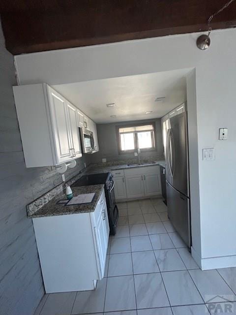 21 Terrace Dr, Pueblo, CO 81001 - kitchen featuring stainless steel appliances, white cabinetry, and a sink