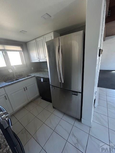 21 Terrace Dr, Pueblo, CO 81001 - kitchen featuring freestanding refrigerator, a sink, white cabinets, and black dishwasher