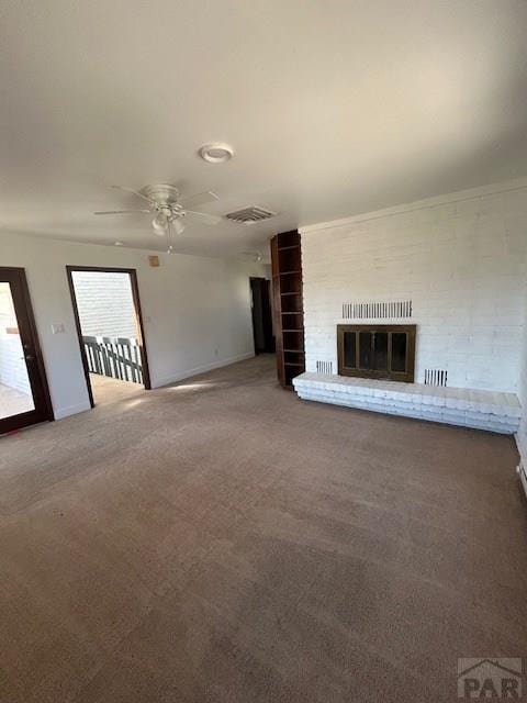 21 Terrace Dr, Pueblo, CO 81001 - unfurnished living room featuring carpet flooring, ceiling fan, a brick fireplace, and baseboards