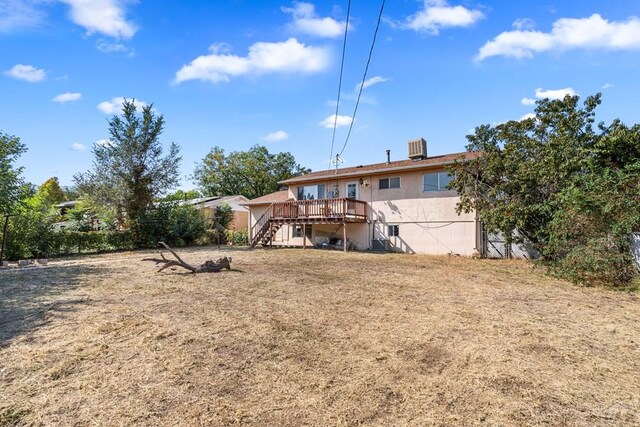 back of property featuring stairway and a wooden deck