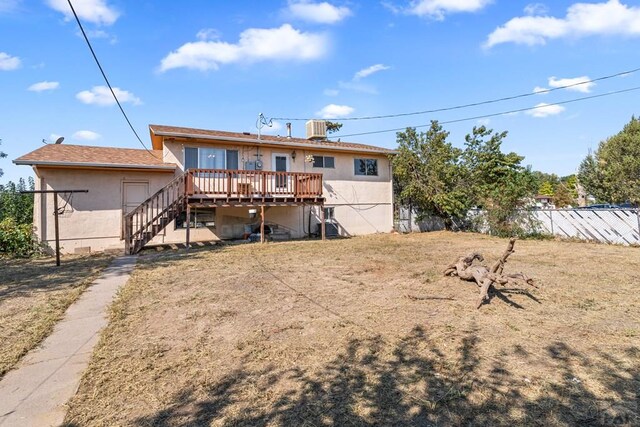 back of house featuring a deck, central AC, fence, stairway, and stucco siding