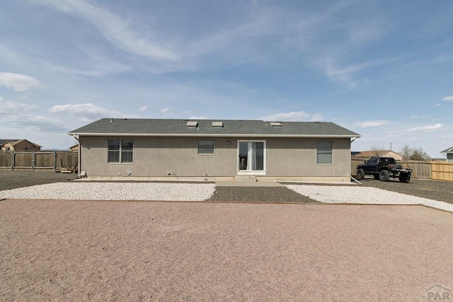 1108 W Meadowmoor Dr, Pueblo West, CO 81007 - rear view of house featuring a patio area, a fenced backyard, and a shingled roof