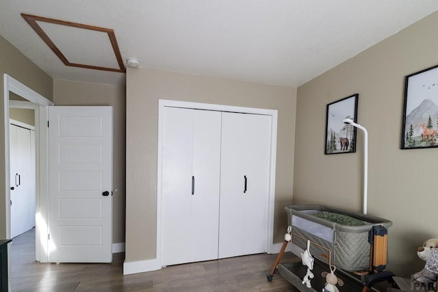 1108 W Meadowmoor Dr, Pueblo West, CO 81007 - bedroom featuring a closet, baseboards, and dark wood finished floors