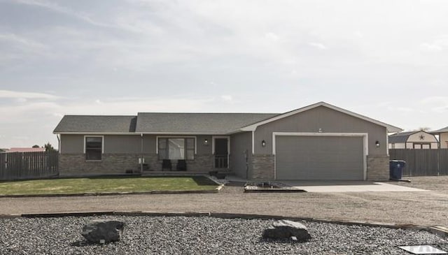1108 W Meadowmoor Dr, Pueblo West, CO 81007 - ranch-style house with driveway, fence, an attached garage, and a front lawn