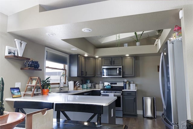 1108 W Meadowmoor Dr, Pueblo West, CO 81007 - kitchen featuring a peninsula, open shelves, light countertops, a sink, and stainless steel appliances