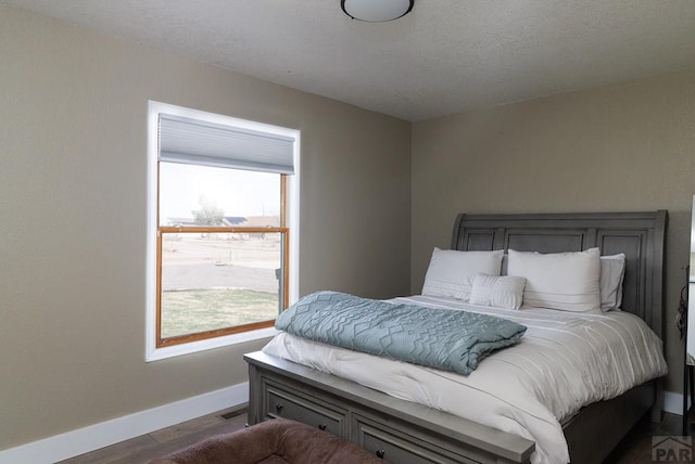 1108 W Meadowmoor Dr, Pueblo West, CO 81007 - bedroom with dark wood-style flooring, baseboards, and visible vents