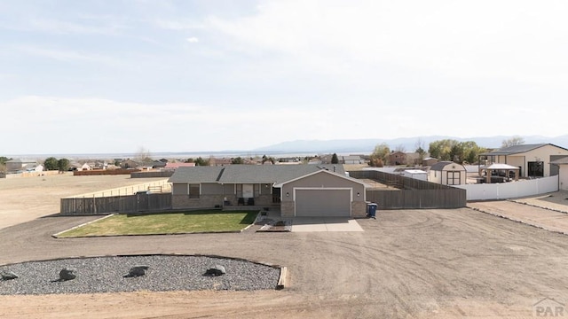 1108 W Meadowmoor Dr, Pueblo West, CO 81007 - ranch-style house featuring a front lawn, fence, a garage, and concrete driveway