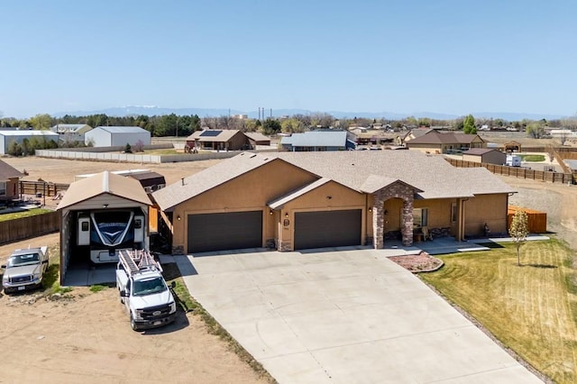 1557 28th Ln, Pueblo, CO 81006 - view of front of house with a garage, driveway, a residential view, stone siding, and roof with shingles