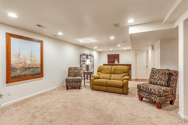 living room with a textured ceiling, carpet, visible vents, and recessed lighting