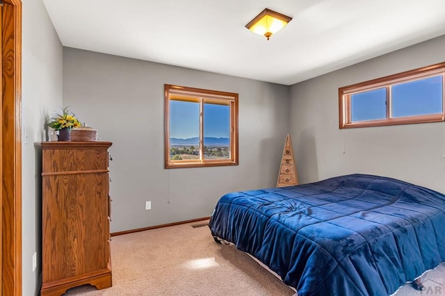 carpeted bedroom with visible vents and baseboards