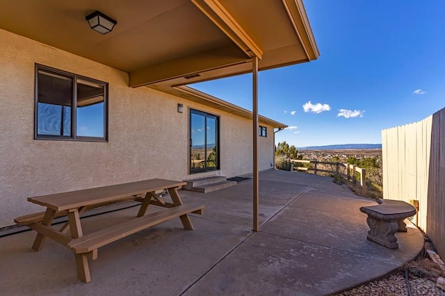 view of patio featuring fence