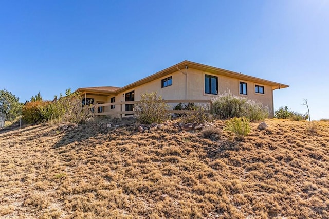 view of side of home with stucco siding