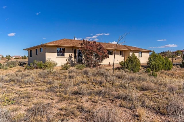 rear view of property with stucco siding