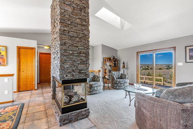 living area with light tile patterned floors, a stone fireplace, lofted ceiling with skylight, and baseboards