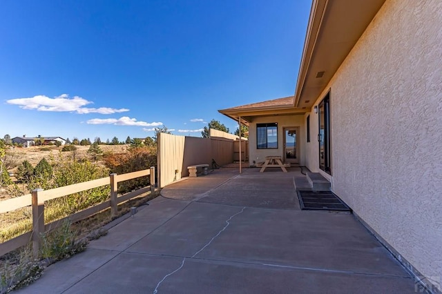 view of patio featuring fence