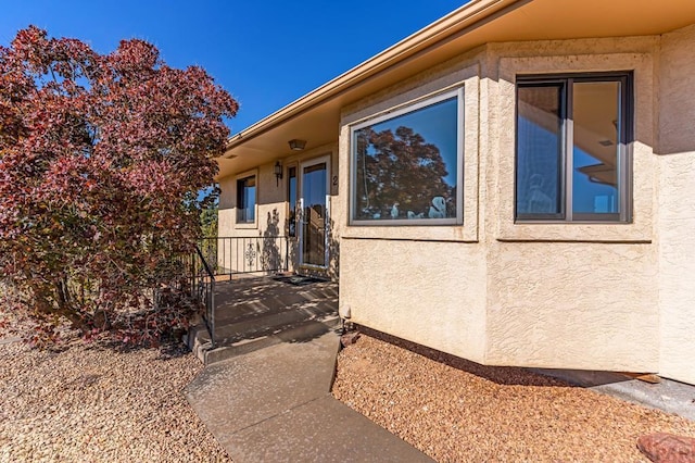 view of side of home with stucco siding