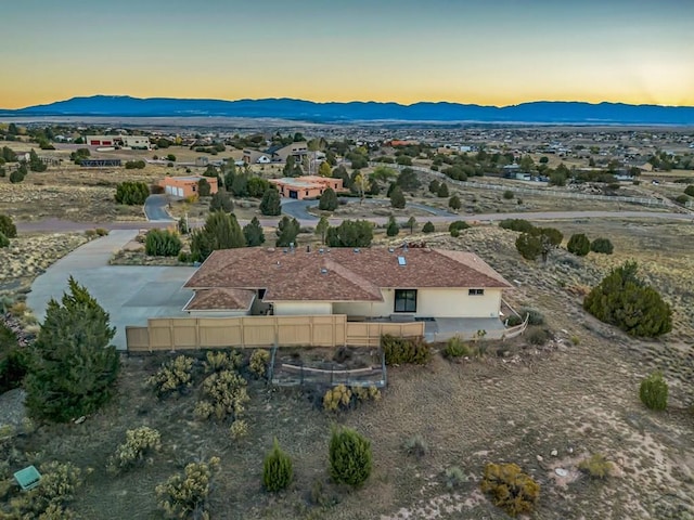 aerial view at dusk featuring a mountain view