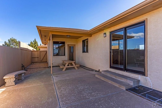 view of patio with entry steps, fence, and visible vents