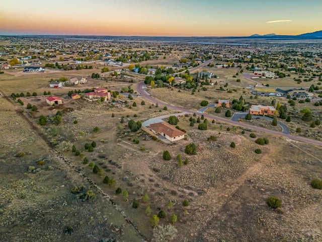 aerial view at dusk featuring a mountain view