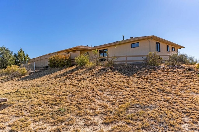 rear view of property featuring fence