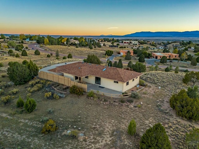 aerial view at dusk featuring a mountain view