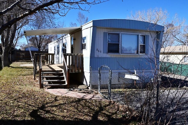 view of front of house featuring a deck and fence