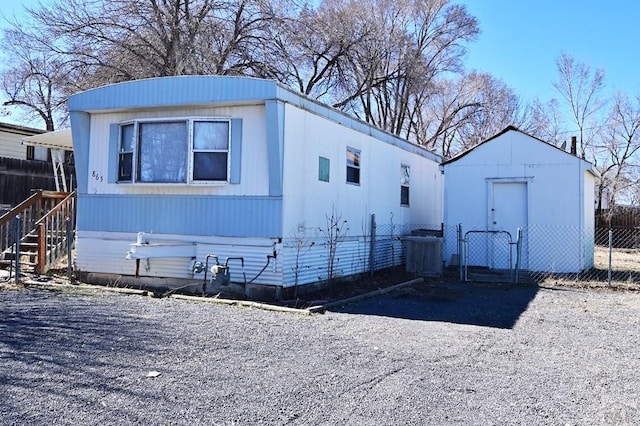 exterior space with an outbuilding and fence