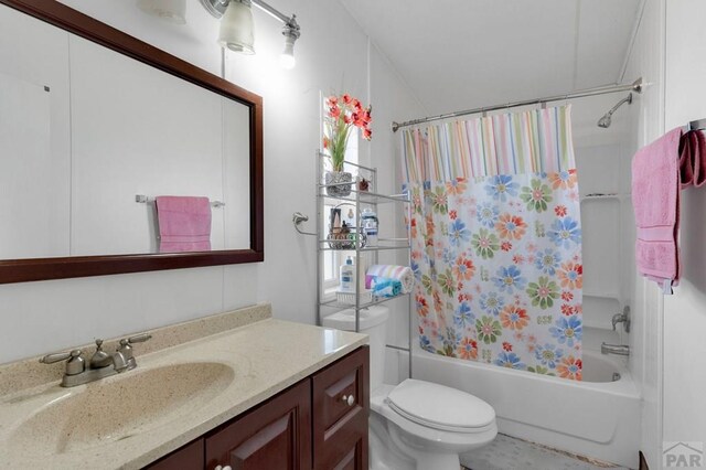 full bathroom featuring shower / tub combo, vanity, and toilet