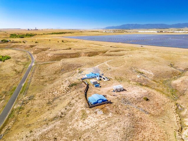 drone / aerial view featuring a rural view and a water and mountain view