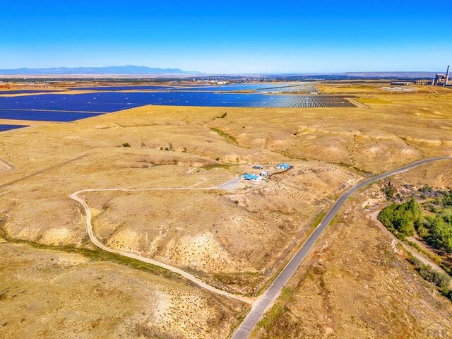 drone / aerial view featuring a water and mountain view