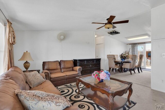 living room featuring light carpet and ceiling fan