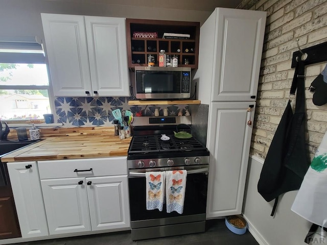 2602 3rd Ave, Pueblo, CO 81003 - kitchen with stainless steel appliances, butcher block countertops, and white cabinetry
