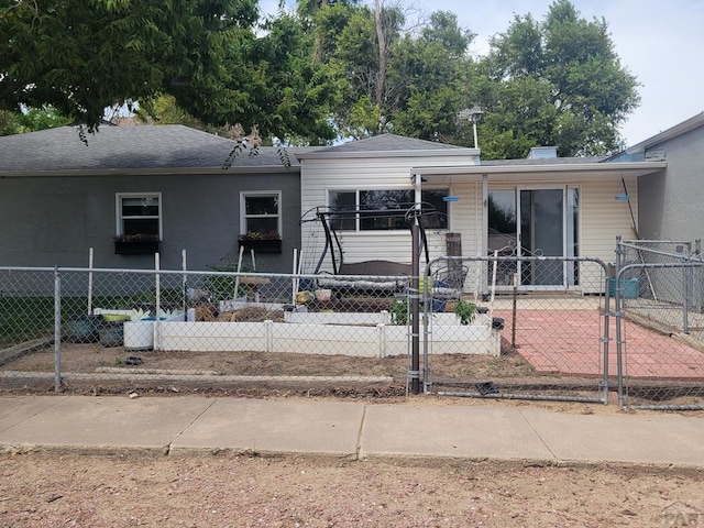 2602 3rd Ave, Pueblo, CO 81003 - view of front of home with a fenced front yard, a gate, and a shingled roof