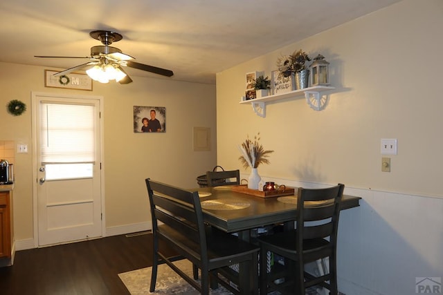 dining area featuring dark wood-style flooring and a ceiling fan