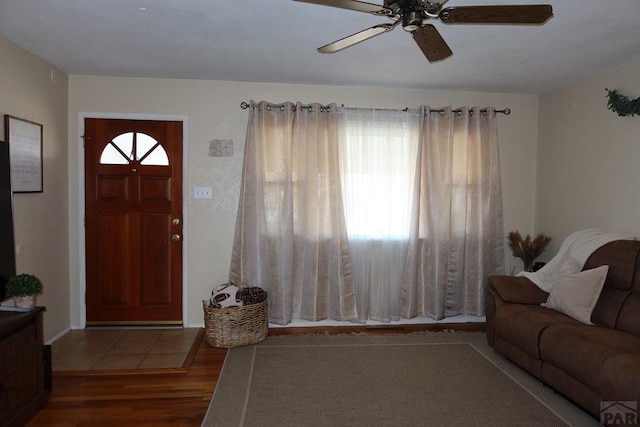 living room featuring a ceiling fan and wood finished floors