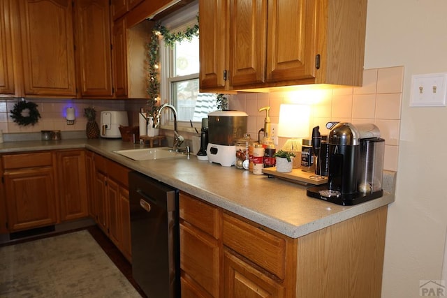 kitchen with light countertops, backsplash, stainless steel dishwasher, brown cabinetry, and a sink