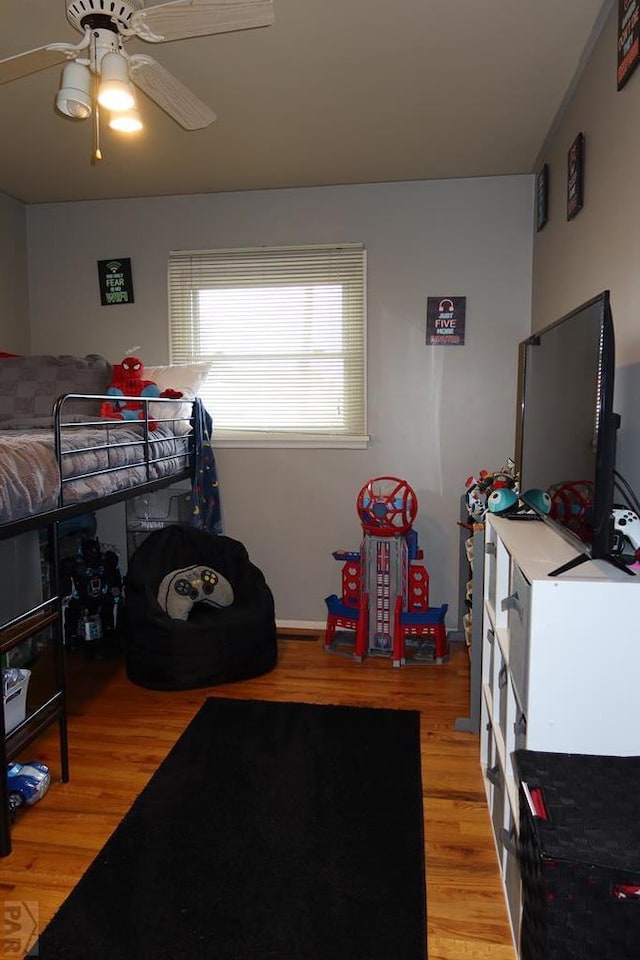 bedroom with light wood-style flooring and a ceiling fan