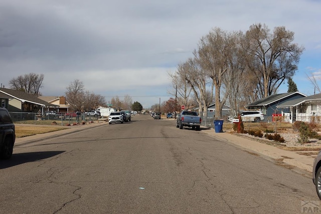 view of street with curbs, sidewalks, and a residential view