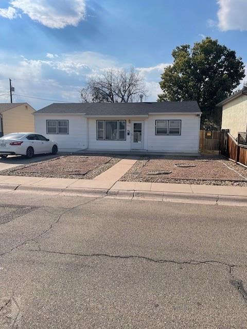 ranch-style house with fence