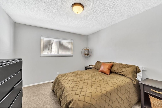 carpeted bedroom featuring a textured ceiling and baseboards