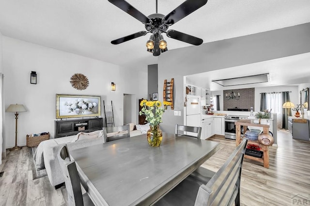 dining space with light wood-style flooring and a ceiling fan