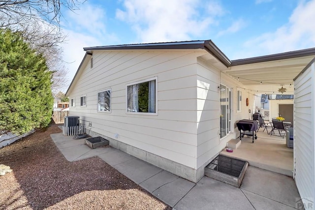 view of property exterior featuring a patio area and central AC unit