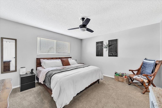 bedroom featuring a textured ceiling, carpet, baseboards, and ceiling fan