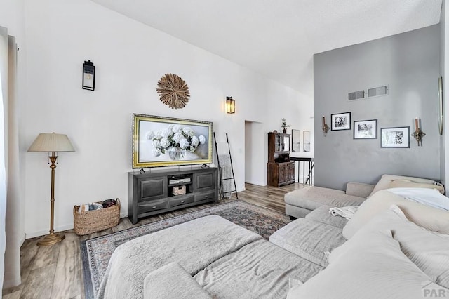 living room with visible vents and wood finished floors