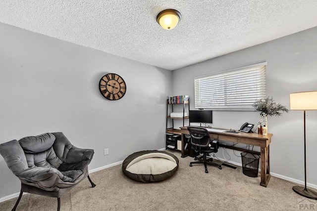 office area with baseboards, carpet floors, and a textured ceiling