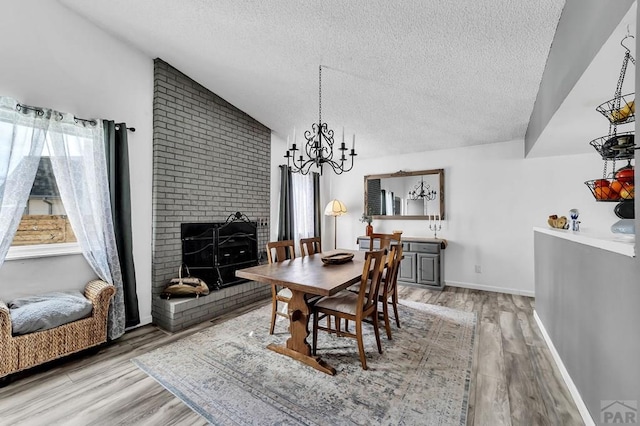 dining space featuring vaulted ceiling, wood finished floors, and a healthy amount of sunlight