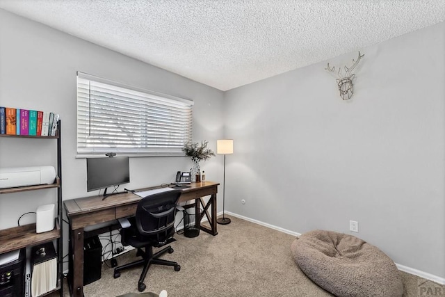 home office featuring baseboards, carpet floors, and a textured ceiling