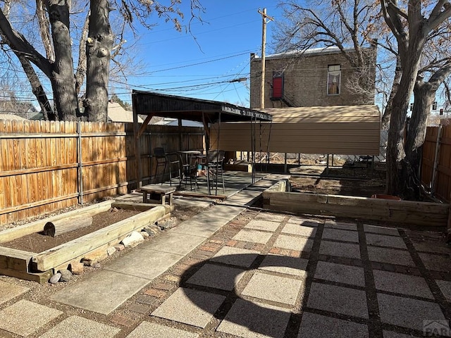 view of patio featuring a fenced backyard and a vegetable garden