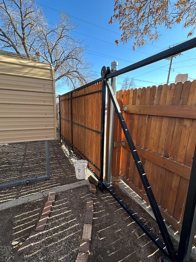 view of gate with fence