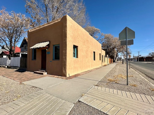 exterior space featuring fence and stucco siding